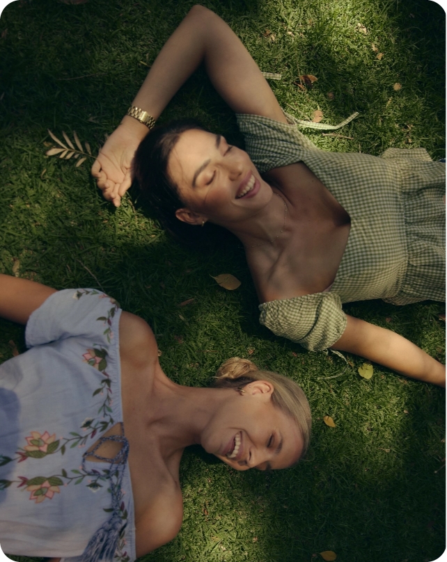 Women lying on grass